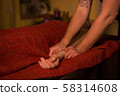 Masseur doing hand massage for female client 58314608