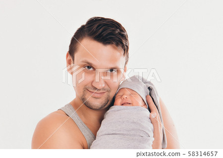 Dad holds the baby in his arms. The concept of educating the father of young children, Happy childhood, a friendly family. 58314657