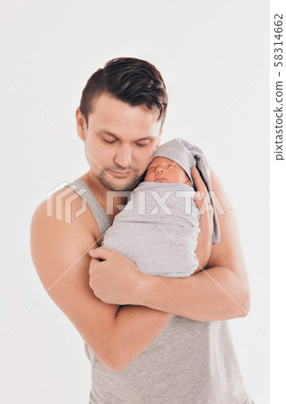 Dad holds the baby in his arms. The concept of educating the father of young children, Happy childhood, a friendly family. 58314662