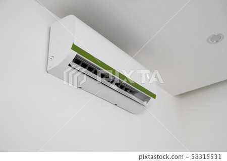 Air conditioner mounted on a white wall in the living room or bedroom. Indooor comfort temperature Air conditioner mounted on a white wall in the living room or bedroom. Indooor comfort temperature 58315531