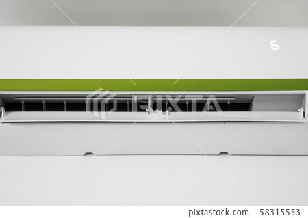 Air conditioner mounted on a white wall in the living room or bedroom. Indooor comfort temperature 58315553