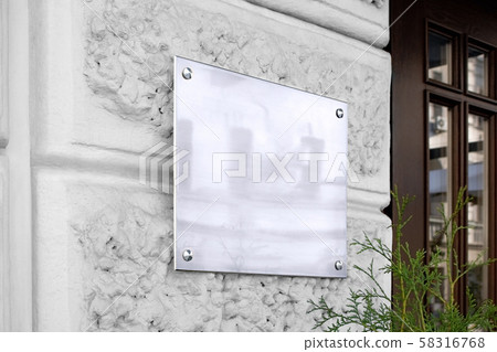 Blank silver glass signboard on textured wall mockup 58316768