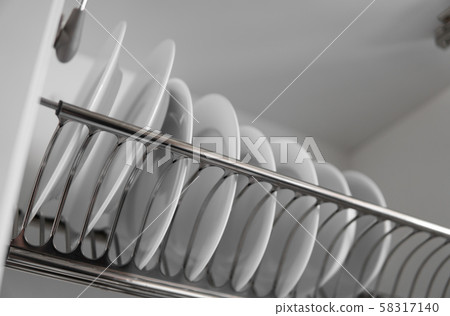 Dish drying metal rack with big nice white clean plates. Traditional comfortable kitchen. Open white 58317140