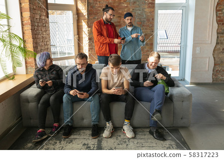 Group of happy young people sharing in social media Group of happy young people sharing in social media 58317223