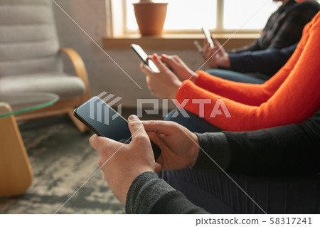 Close up hands of group of happy young people sharing in social media 58317241