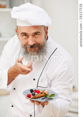 Senior Chef Presenting Dessert Senior Chef Presenting Dessert 58317538