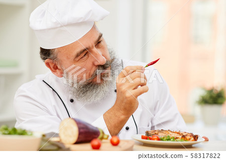 Senior Chef Holding Chili Pepper Senior Chef Holding Chili Pepper 58317822