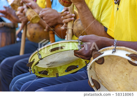 Tambourine, berimbau and others instruments player Tambourine, berimbau and others instruments player 58318065