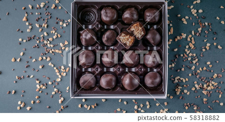 Food banner: Handmade chocolates with honey and nuts. Gourmet Chocolate in a Gift Box. Top view 58318882