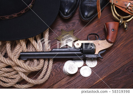 Old western gun with marshal badge and silver Old western gun with marshal badge and silver 58319398
