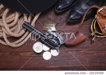 Old western gun with marshal badge and silver Old western gun with marshal badge and silver 58319399