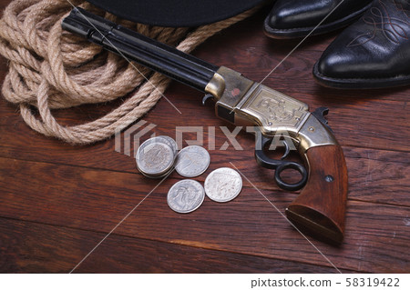 Old western gun with silver dollars with hat, rope Old western gun with silver dollars with hat, rope 58319422