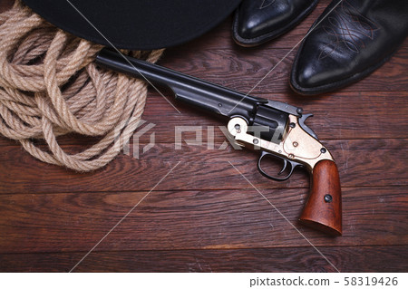Old western gun with hat, rope and boots 58319426