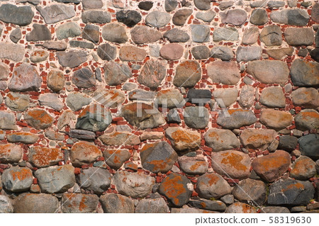 Image of an ancient wall of boulders and bricks covered with moss 58319630