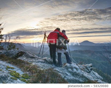 Two wildlife photographers at tripod with set Two wildlife photographers at tripod with set 58320080