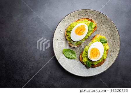 Toast with avocado and egg Toast with avocado and egg 58320733
