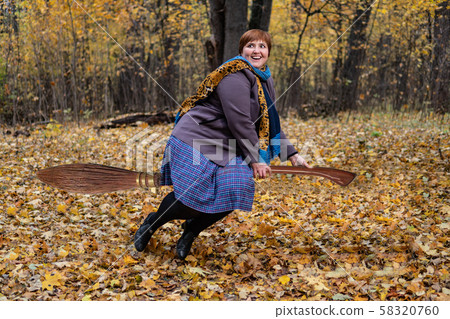 Witch girl on a broomstick Halloween in the autumn forest Witch girl on a broomstick Halloween in the autumn forest 58320760