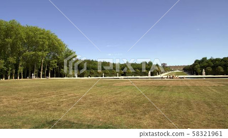 Pan shot of palace in gardens of Versailles in France during spring time Pan shot of palace in gardens of Versailles in France during spring time 58321961