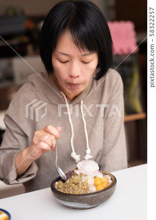 Asian woman eat shaved ice 58322257