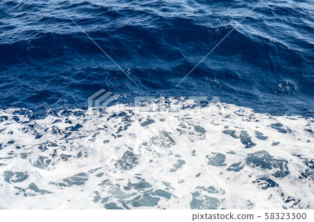 Background blue sea with small waves and white foam Background blue sea with small waves and white foam 58323300