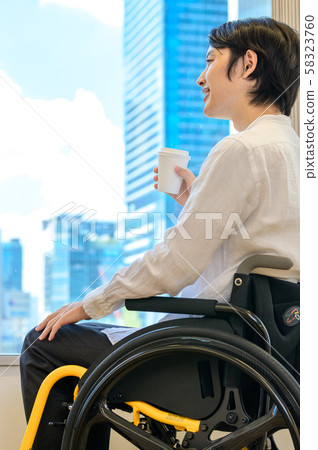 A man riding a wheelchair 58323760