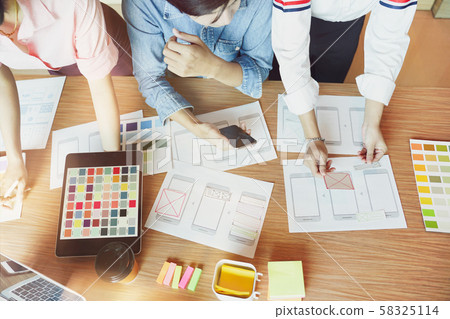 Mobile apps developers team designing, discussing Mobile apps developers team designing, discussing 58325114