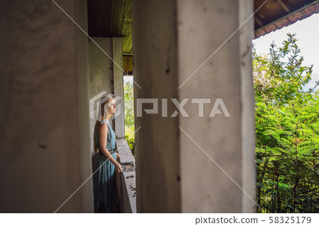 Woman tourist in abandoned and mysterious hotel in Bedugul. Indonesia, Bali Island. Bali Travel 58325179