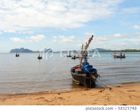 Fishing boats moored along the beach 58325748