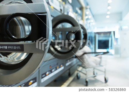 Single life concept, washing machines at laundromat 153 58326860