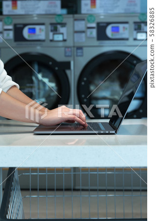 Single life concept, washing machines at laundromat 111 58326885