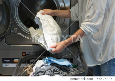 Single life concept, washing machines at laundromat 104 58326887