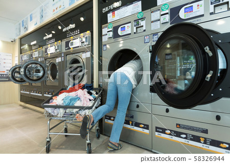 Single life concept, washing machines at laundromat 065 58326944