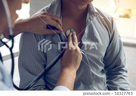 Asian doctor is using a stethoscope listen to the 58327763