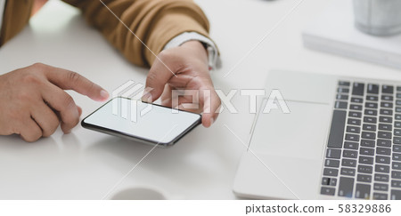 Young businessman looking at information in blank Young businessman looking at information in blank 58329886
