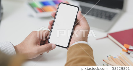 Close-up view of businessman holding blank screen Close-up view of businessman holding blank screen 58329891