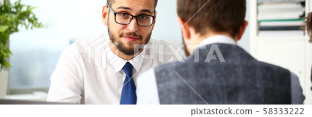 Two smiling clerk businessmen deliberate on problem Two smiling clerk businessmen deliberate on problem 58333222