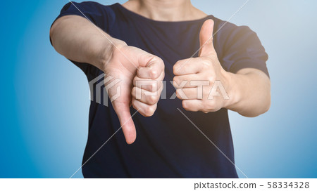 Woman showing thumbs up and thumbs down. Social media, marketing and communication Woman showing thumbs up and thumbs down. Social media, marketing and communication 58334328