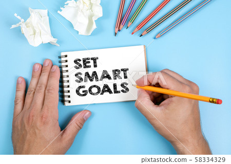 Set Smart Goals. Notepad on blue table Set Smart Goals. Notepad on blue table 58334329