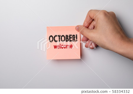 October, welcome. Sticky note on a white background October, welcome. Sticky note on a white background 58334332