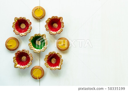Happy Diwali - Clay Diya lamps lit during Dipavali, Hindu festival of lights celebration Happy Diwali - Clay Diya lamps lit during Dipavali, Hindu festival of lights celebration 58335199