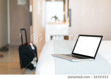 Working with a laptop on the bed Working with a laptop on the bed 58335415