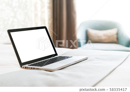 Working with a laptop on the bed Working with a laptop on the bed 58335417