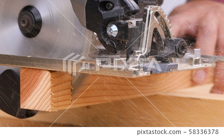 Cutting wood with an electric saw 58336378