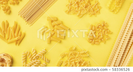 A panorama of Italian pasta, shot from the top on a yellow background, a flat lay banner 58336526