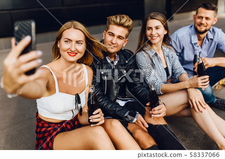 A group of cheerful friends, guys and girls walk A group of cheerful friends, guys and girls walk 58337066