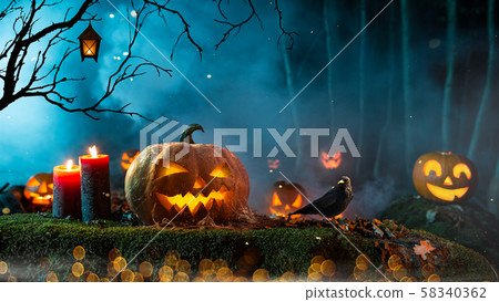 Halloween pumpkins on dark spooky forest. 58340362