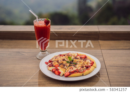 Delicious strawberry pizza on a balinese tropical nature background. Bali island, Indonesia 58341257