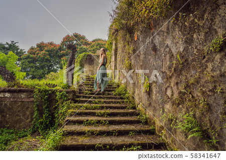 Woman tourist in abandoned and mysterious hotel in Bedugul. Indonesia, Bali Island. Bali Travel Woman tourist in abandoned and mysterious hotel in Bedugul. Indonesia, Bali Island. Bali Travel 58341647