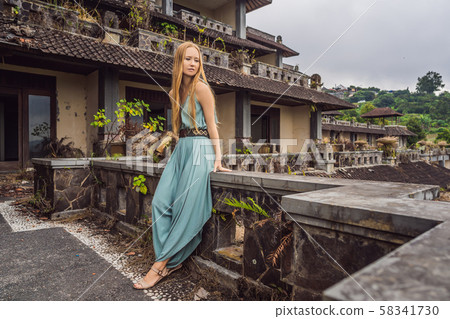 Woman tourist in abandoned and mysterious hotel in Bedugul. Indonesia, Bali Island. Bali Travel Woman tourist in abandoned and mysterious hotel in Bedugul. Indonesia, Bali Island. Bali Travel 58341730