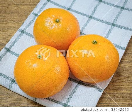 Three Ripe Oranges on A Wooden Table Three Ripe Oranges on A Wooden Table 58342923
